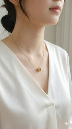 young woman wearing gold-plated hypoallergenic necklace, showing their anti-tarnish shine suitable for sensitive skin and daily wear