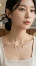 young woman wearing gold-plated hypoallergenic necklace, showing their anti-tarnish shine suitable for sensitive skin and daily wear