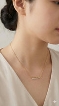 young woman wearing gold-plated hypoallergenic necklace, showing their anti-tarnish shine suitable for sensitive skin and daily wear