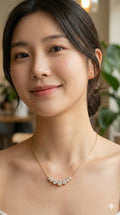 young woman wearing gold-plated hypoallergenic necklace, showing their anti-tarnish shine suitable for sensitive skin and daily wear