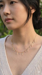 young woman wearing gold-plated hypoallergenic necklace, showing their anti-tarnish shine suitable for sensitive skin and daily wear