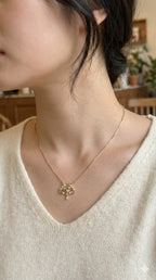young woman wearing gold-plated hypoallergenic necklace, showing their anti-tarnish shine suitable for sensitive skin and daily wear