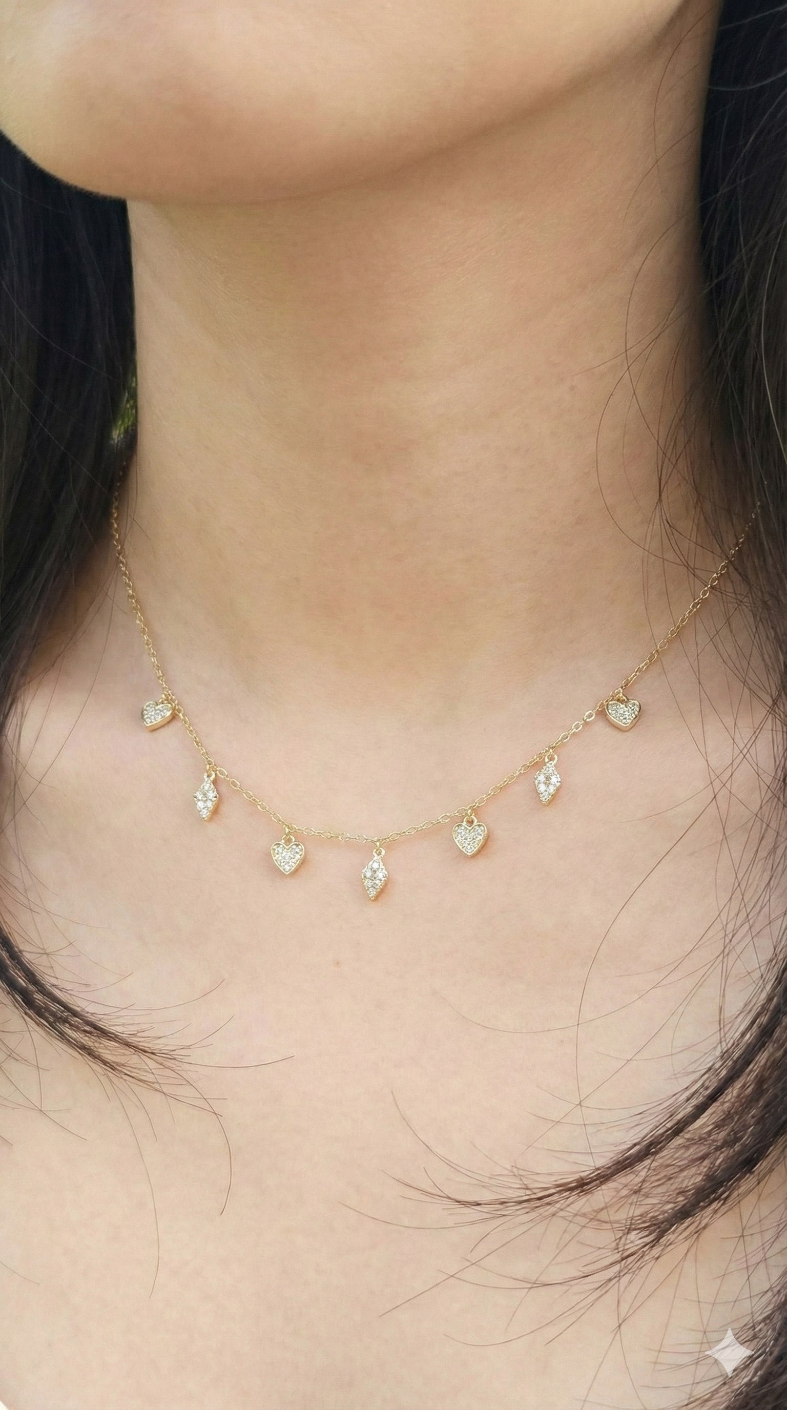 young woman wearing gold-plated hypoallergenic necklace, showing their anti-tarnish shine suitable for sensitive skin and daily wear