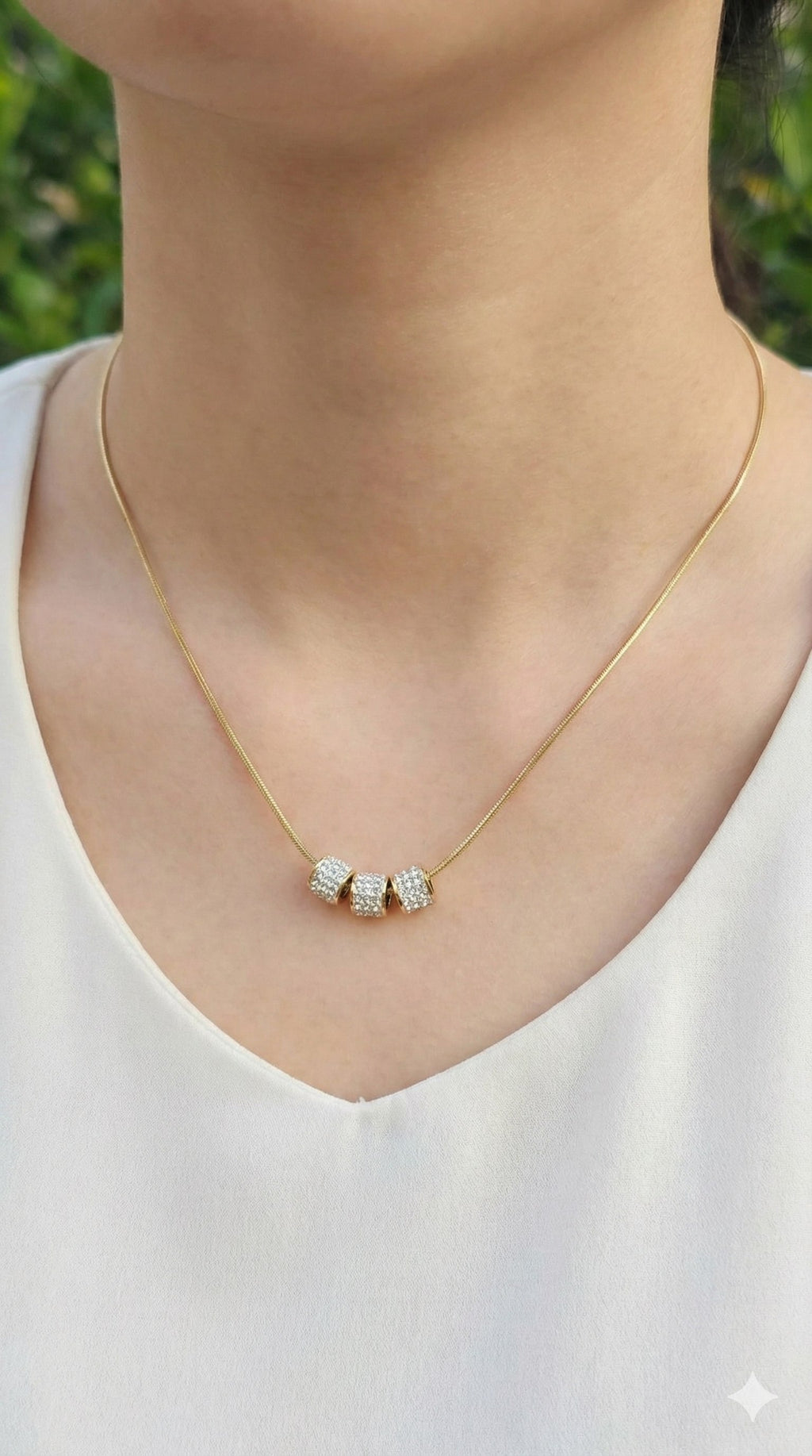 young woman wearing gold-plated hypoallergenic necklace, showing their anti-tarnish shine suitable for sensitive skin and daily wear