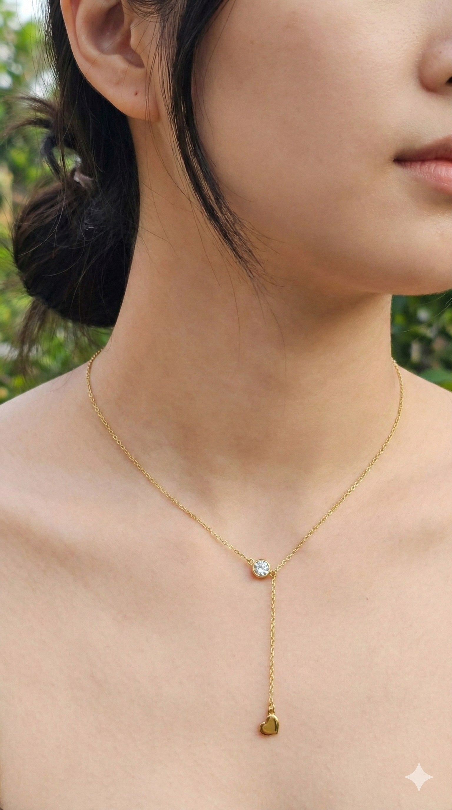young woman wearing gold-plated hypoallergenic necklace, showing their anti-tarnish shine suitable for sensitive skin and daily wear