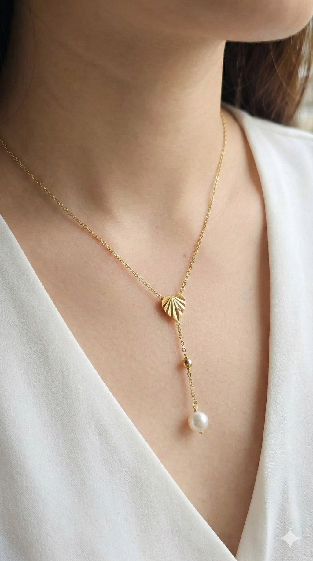 young woman wearing gold-plated hypoallergenic necklace, showing their anti-tarnish shine suitable for sensitive skin and daily wear