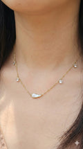 young woman wearing gold-plated hypoallergenic necklace, showing their anti-tarnish shine suitable for sensitive skin and daily wear