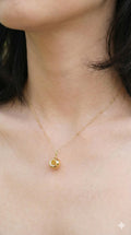 young woman wearing gold-plated hypoallergenic necklace, showing their anti-tarnish shine suitable for sensitive skin and daily wear