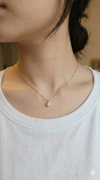 young woman wearing gold-plated hypoallergenic necklace, showing their anti-tarnish shine suitable for sensitive skin and daily wear